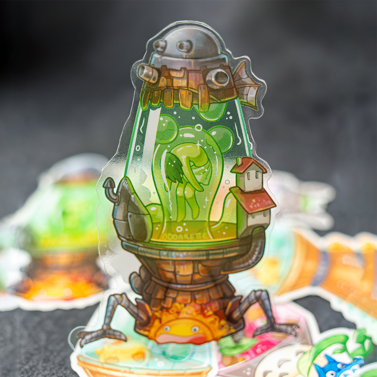 A colorful, transparent Ghilbi-inspired sticker featuring a whimsical, robot-like creature with a green body in a lava lamp.