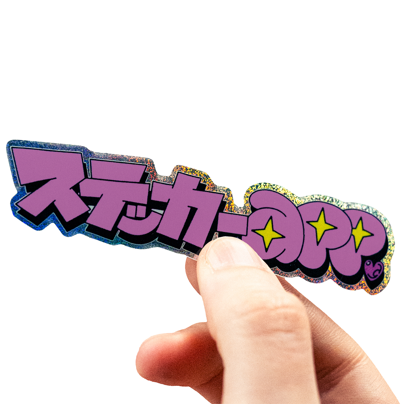 Hand holding a Pixie Dust sticker with Japanese text with 100 percent white layer, against a white background