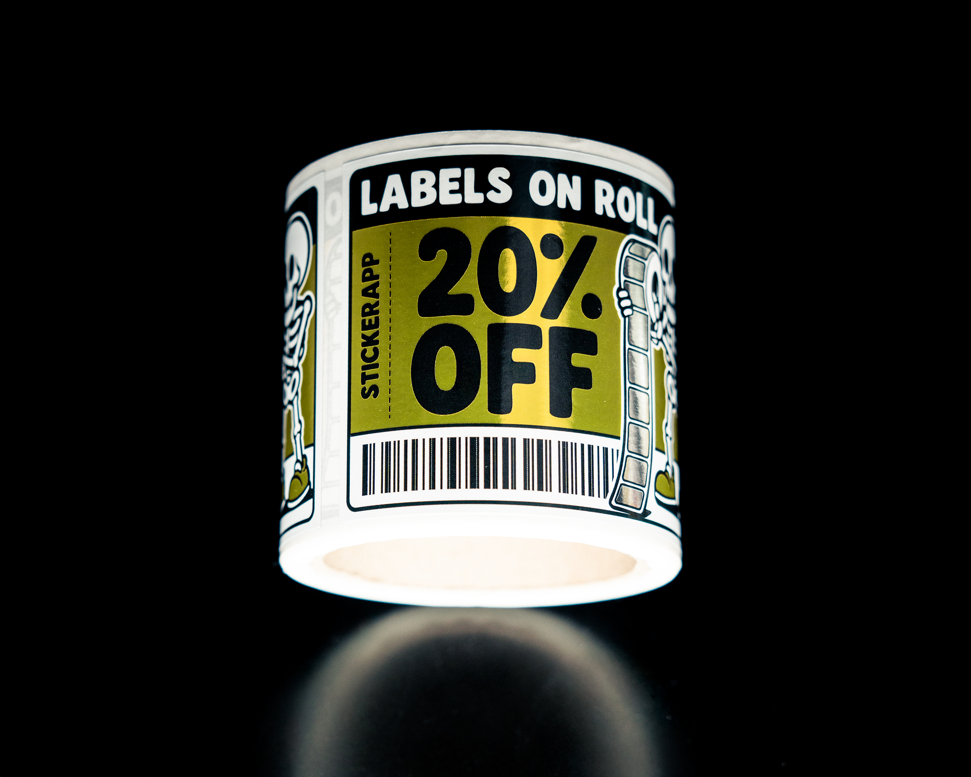 A label on roll with a "20% OFF" message, featuring skeleton illustrations. Shot against a black background.