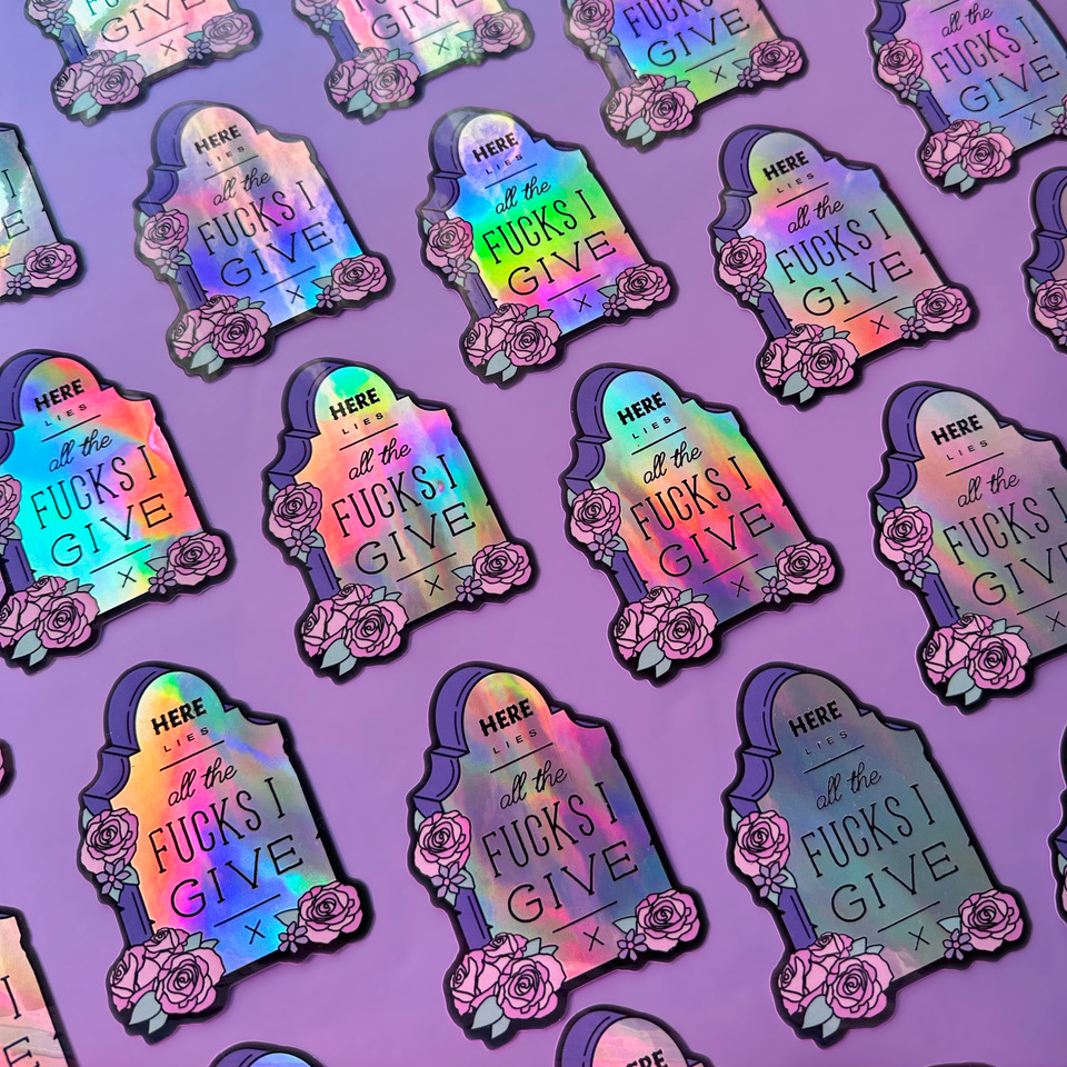 Holographic die cut sticker with quote "Here lies all the fucks I give"